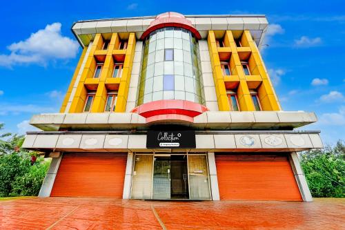 a building with orange doors in front of it at Collection O Kottayam Formerly Sap Inn in Kottayam