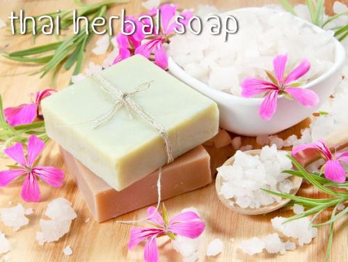 a bar of soap and flowers on a table at The Mud - Eco Hotel in Ban Bang Po