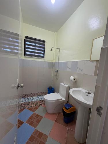 a bathroom with a toilet and a sink at Anda Seabreeze Pension Haus in Anda