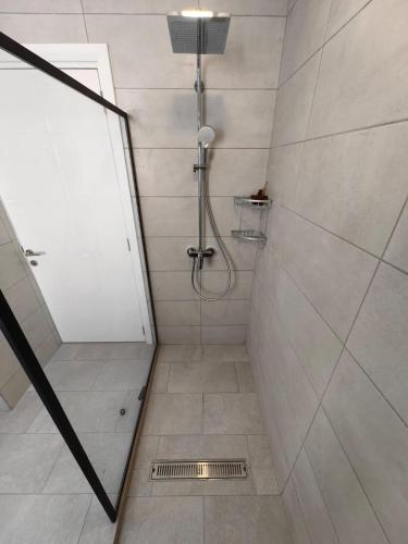 a bathroom with a shower with a drain at J'Vais Residence in Flic-en-Flac