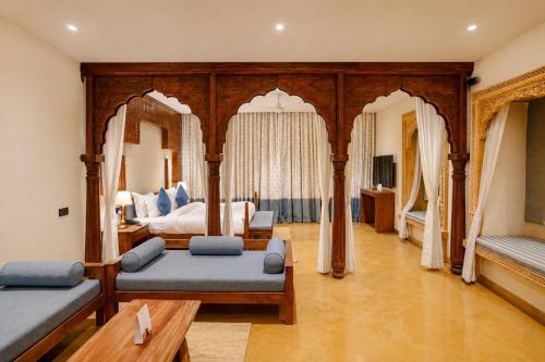 a large bedroom with a bed and a couch at Hotel Aurea Jaisalmer in Jaisalmer