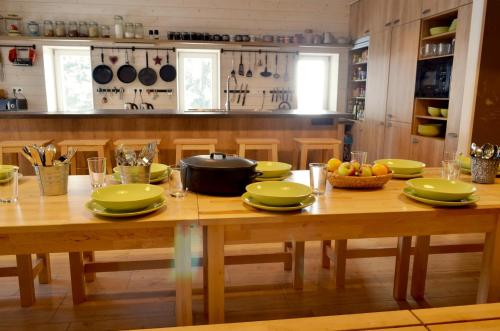 a wooden table with green plates and a pot on it at Chata Magistrála in Bedřichov