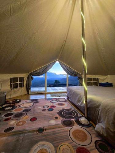 a bedroom with a large bed with a view of the ocean at เขาเจ้าขา-เต็นท์กระโจมเขาค้อ in Khao Kho