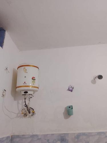 a white room with a lamp on the wall at Dev Giri Guest House in Phata