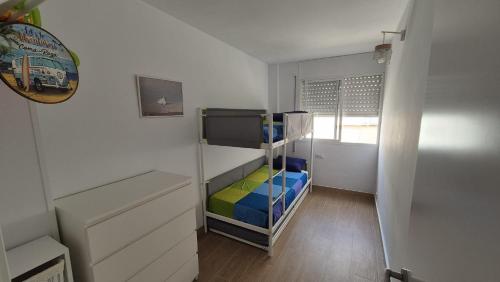 a small room with a bunk bed in a room at Comarruga Playa in Comarruga