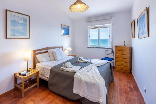 a bedroom with a bed with towels on it at incredible view- T1 Salema in Salema
