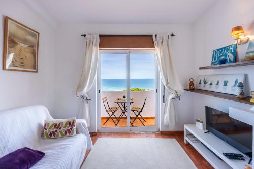 a living room with a view of the ocean at incredible view- T1 Salema in Salema