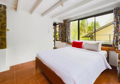 a bedroom with a white bed and a window at Villa W-5 Villa Private Pool Lembang, Bandung in Bandung
