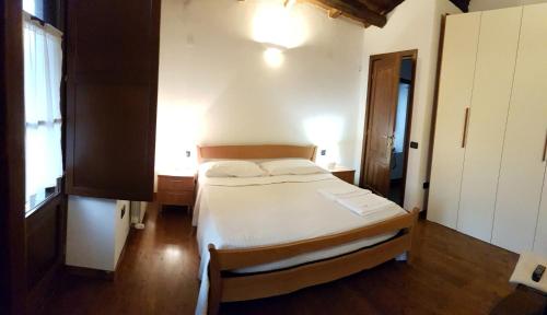 a bedroom with a bed and a desk and a window at Il Fienile in Barete