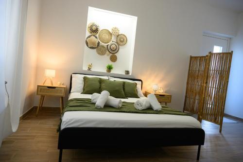 a bedroom with a bed with plates on the wall at ORIGINI - Dimora tra murgia e mare in Toritto