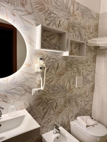 a bathroom with a sink and a toilet at MiraMare Residence Cefalú in Cefalù