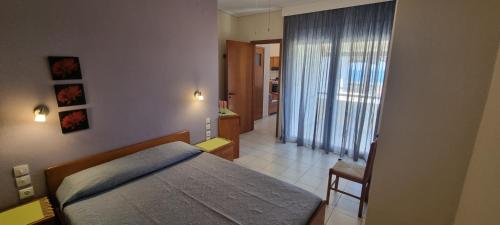 a bedroom with a bed and a room with a hallway at 5 Suites Αγιόκαμπος Αγιάς in Agiokampos