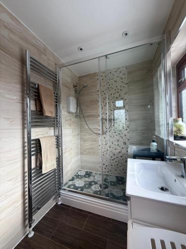 a bathroom with a shower and a sink at 16 Bentley Road - Uttoxeter, Comfortable accommodations, SHARED SHOWER ROOM, NO BREAKFAST in Uttoxeter
