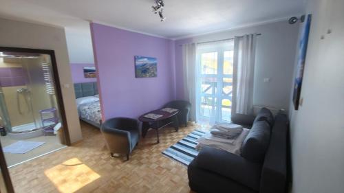 a living room with a couch and a bedroom at Leniwy Motyl in Rajcza