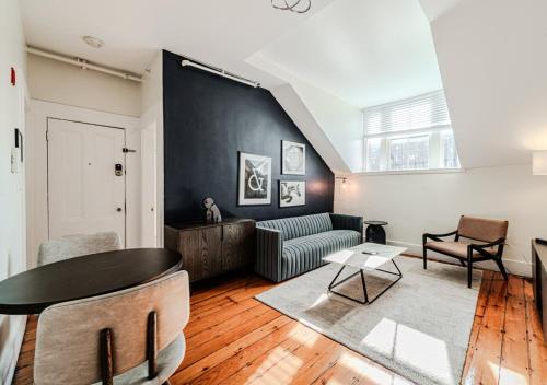 a living room with a table and a couch at Beacon Hill Nights in Boston