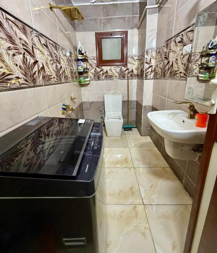 a bathroom with a sink and a toilet at Center Apartment in Aswan