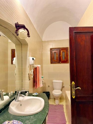 a bathroom with a sink and a toilet at Al Baeirat Hotel in Luxor