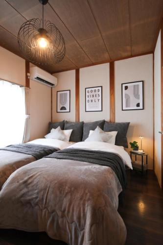 a bedroom with two beds in a room at KiyosuBase2 in Kiyosu
