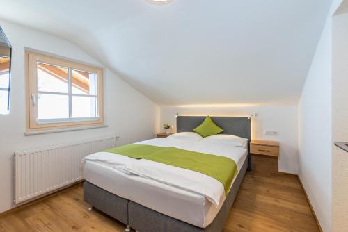 a bedroom with a large bed and a window at Apartments Frechhof in Schladming