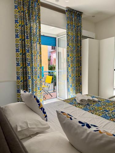 a bedroom with two beds and a sliding glass door at Ballaro's Vibe Historical Apartment Cathedral District in Palermo