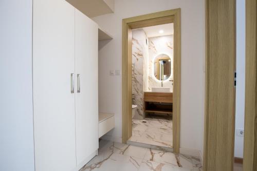 a bathroom with a sink and a mirror at SoleMare One-Bedroom Apartment in Burgas