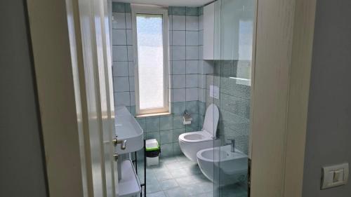a bathroom with a toilet and a sink at AA Tirana Center View in Tirana