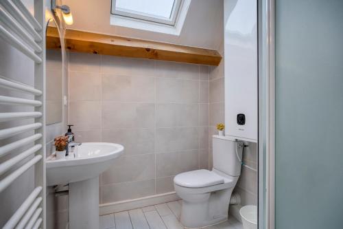 a bathroom with a toilet and a sink at COLIVING - bedroom Salon & TV in Saint-Jean-de-Gonville