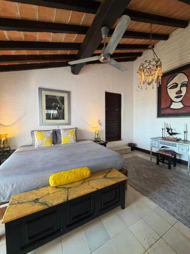 a bedroom with a large bed and a table at Casa Portillo in Puerto Vallarta