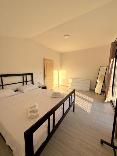 a bedroom with a large bed with two towels on it at AZA holiday in Kotor