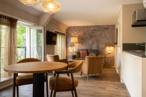 a kitchen and living room with a table and chairs at Juuls Domburg in Domburg