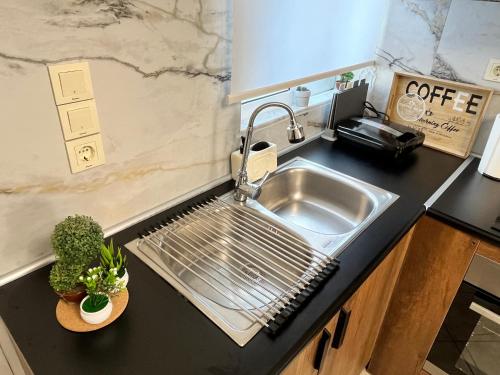 a kitchen with a stainless steel sink and a counter at Windmill view apartment in Antimácheia