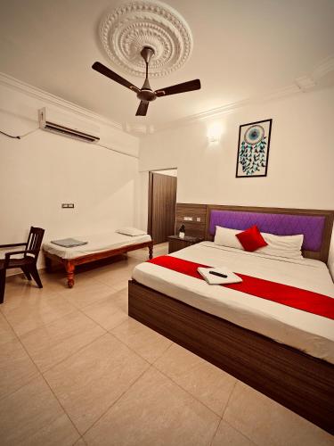 a bedroom with a bed and a ceiling fan at Dreamy serenity beach side in Pondicherry