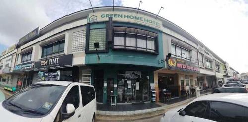 a white van parked in front of a building at Hotel O Green Home Hotel in Sepang