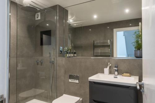 a bathroom with a shower and a toilet and a sink at Fairsky - Sea Views and Allocated Parking in Carbis Bay