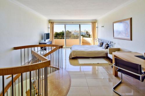 a hotel room with a bed and a balcony at Vila Castelo Parque in Ferragudo