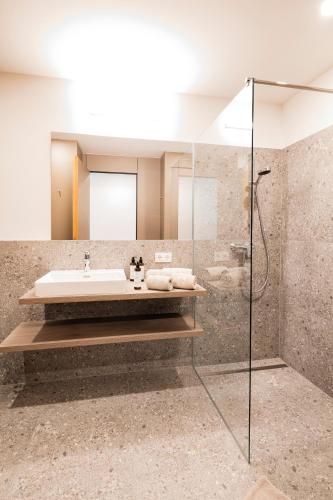 a bathroom with a sink and a shower at CIRCLE Boutique Hotel Melk in Melk