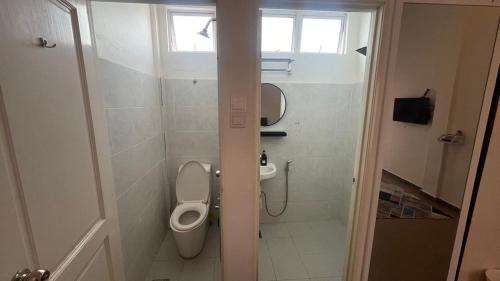 a bathroom with a toilet and a sink at Hotel O HNR INN in Kuala Terengganu