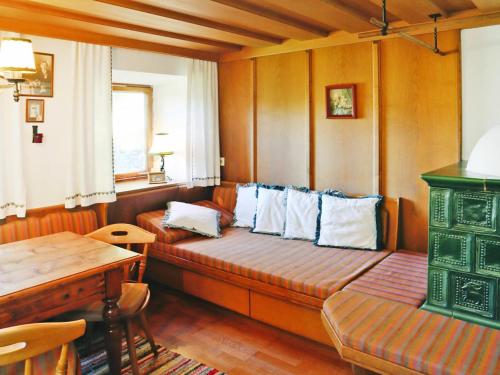 a living room with a couch and a table at Farmhouse in Kössen near Kitzbühel Alps in Kössen