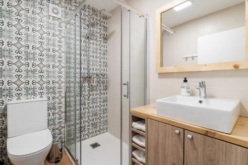 a bathroom with a toilet and a sink and a shower at Casa Pinhão De Sousa in Vieira do Minho