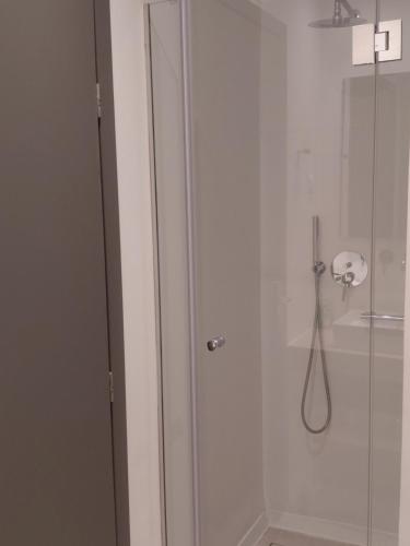 a shower in a bathroom with a glass door at Aqua villa Studio II in Elafonisos