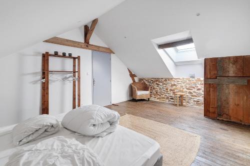 a bedroom with a bed in a attic at Bulle de Douceur avec Spa in Vallons-de-l'Erdre