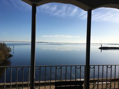 a view of a lake from a balcony at Port Rive Gauche Roseliere in Marseillan