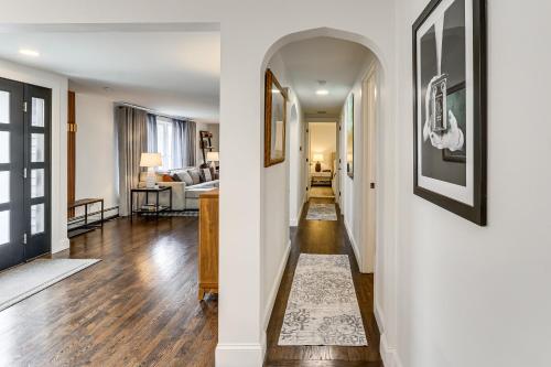 a hallway of a home with white walls and wood floors at Charming Connecticut Hideaway: Year-Round Fun! in Middlefield