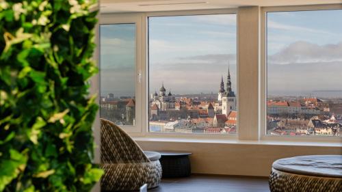 a room with a view of a city from a window at Radisson Blu Hotel Olümpia in Tallinn