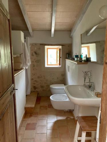 a bathroom with a sink and a toilet and a mirror at Can Peñes in Port d'Andratx