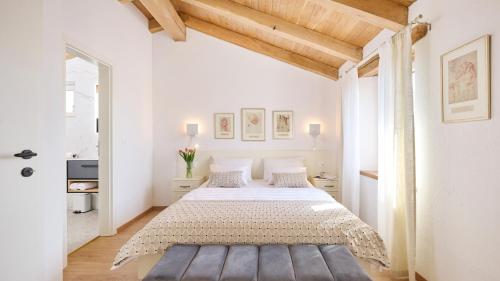 a white bedroom with a large bed in a room at Casa Pove by Villas Guide in Donje Baredine