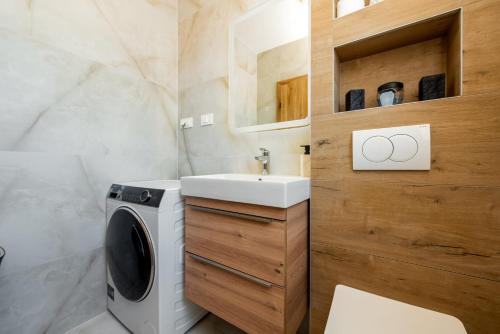 a bathroom with a washing machine and a sink at Villa Antonio ZadarVillas in Nin