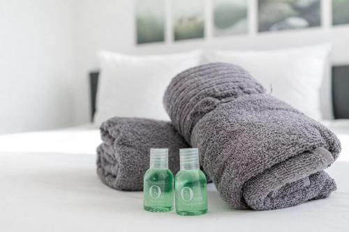 a towel and two bottles of soap on a table at COLIVING - bedroom - TV- Private Bathroom in Saint-Jean-de-Gonville