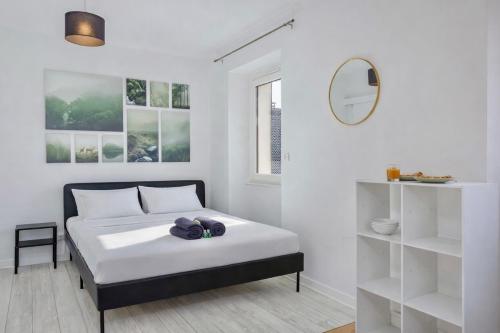 a white bedroom with a bed with towels on it at COLIVING - bedroom - TV- Private Bathroom in Saint-Jean-de-Gonville