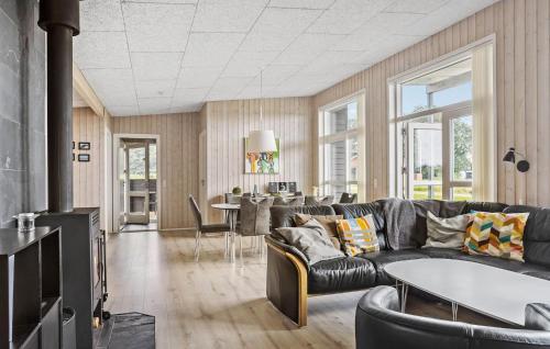 a living room with a couch and a table at Awesome Home In Haderslev With Sauna in Haderslev
